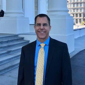 mark ludwig standing in front of government building